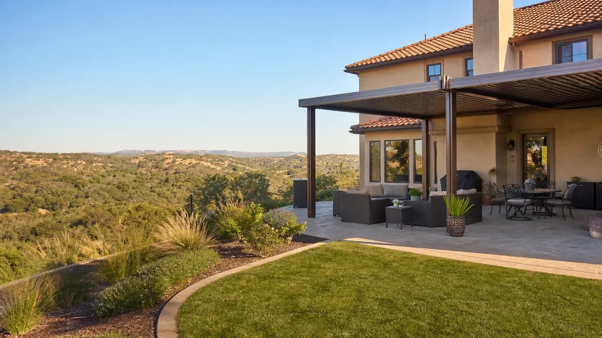 Hillside Mediterranean-style home in the foothills with a covered patio overlooking oak woodland