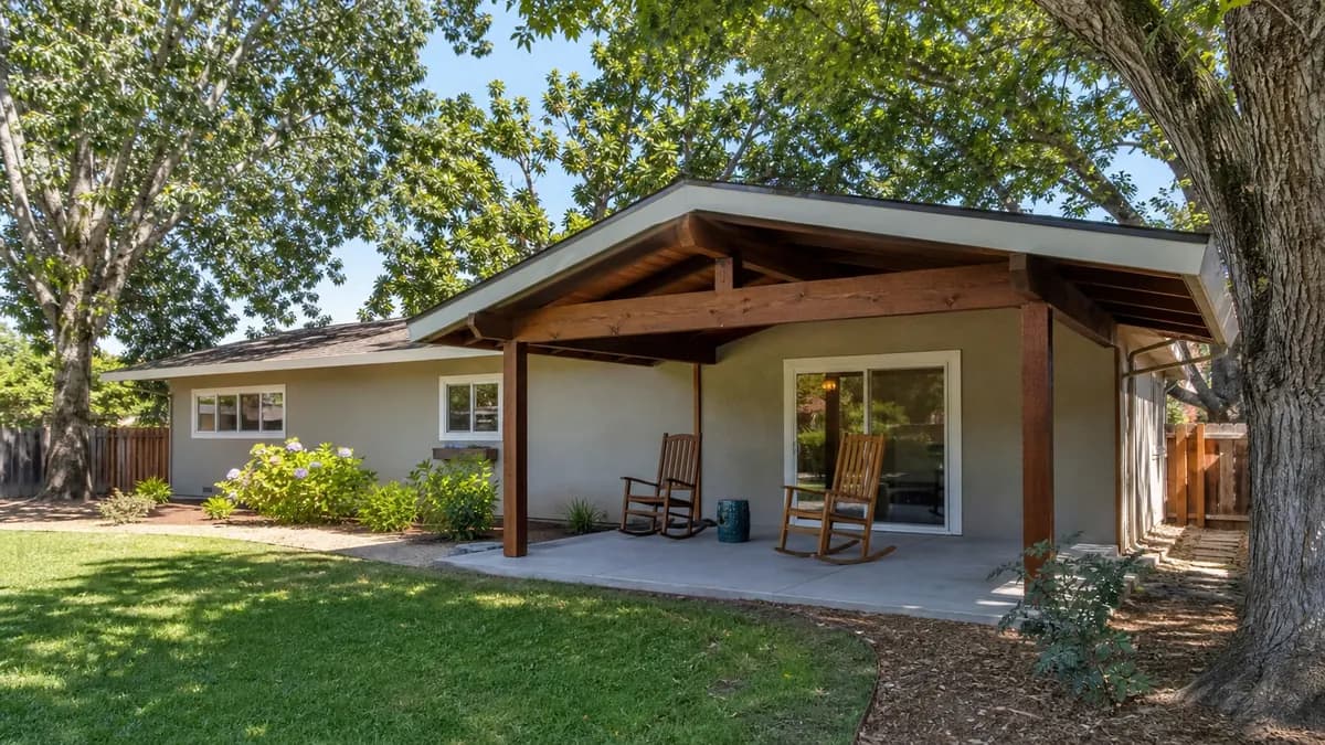 Solid wood patio cover with exposed beams on a 1960s ranch home
